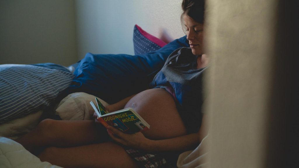 Schwangere Frau liest