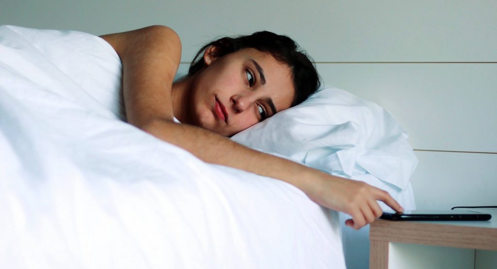 woman lying in bed asleep waking up