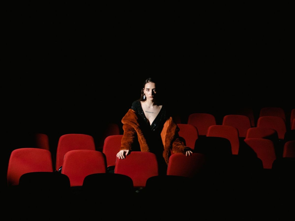 Frau steht im dunklen Kino