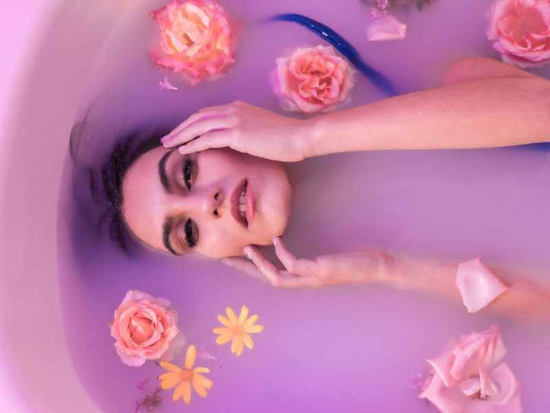 Frau in Badewanne mit Blumen