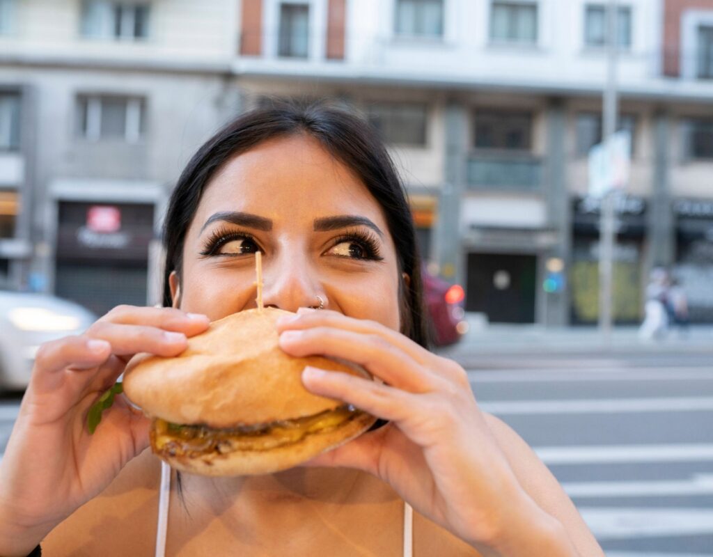 A woman eats a burger