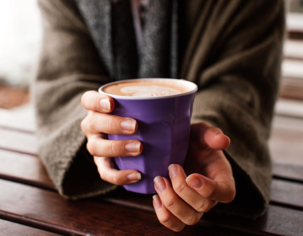 Hände mit Kaffeebecher