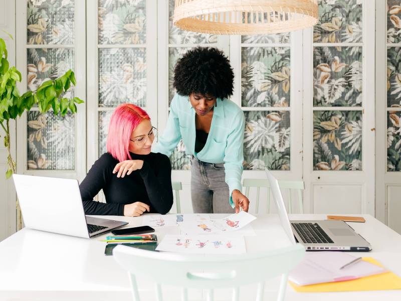 Zwei Frauen schauen sich Bilder im Büro an