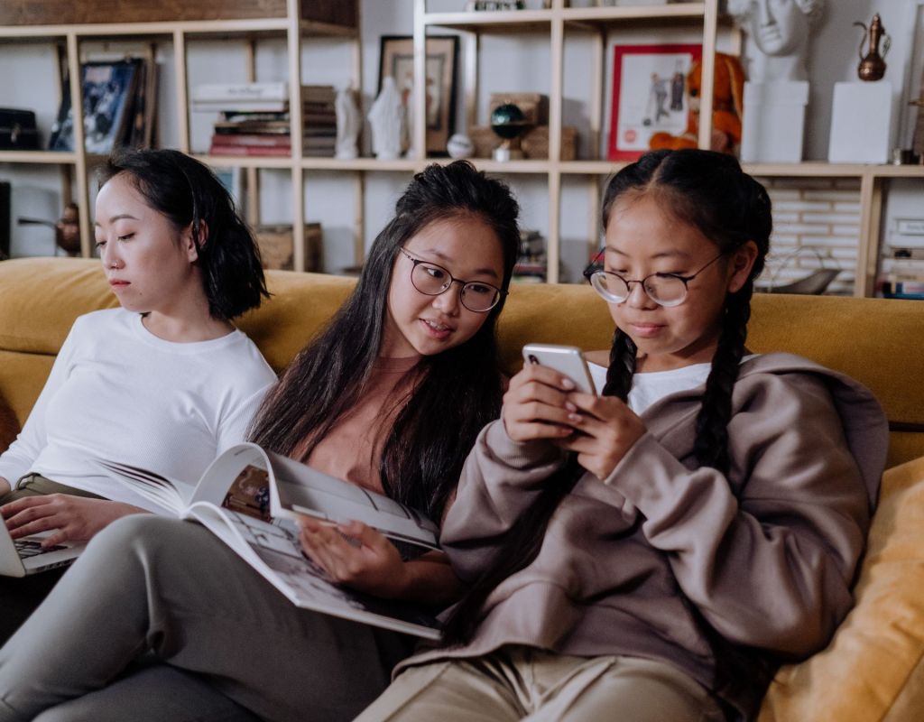 Drei Frauen sitzen auf Sofa