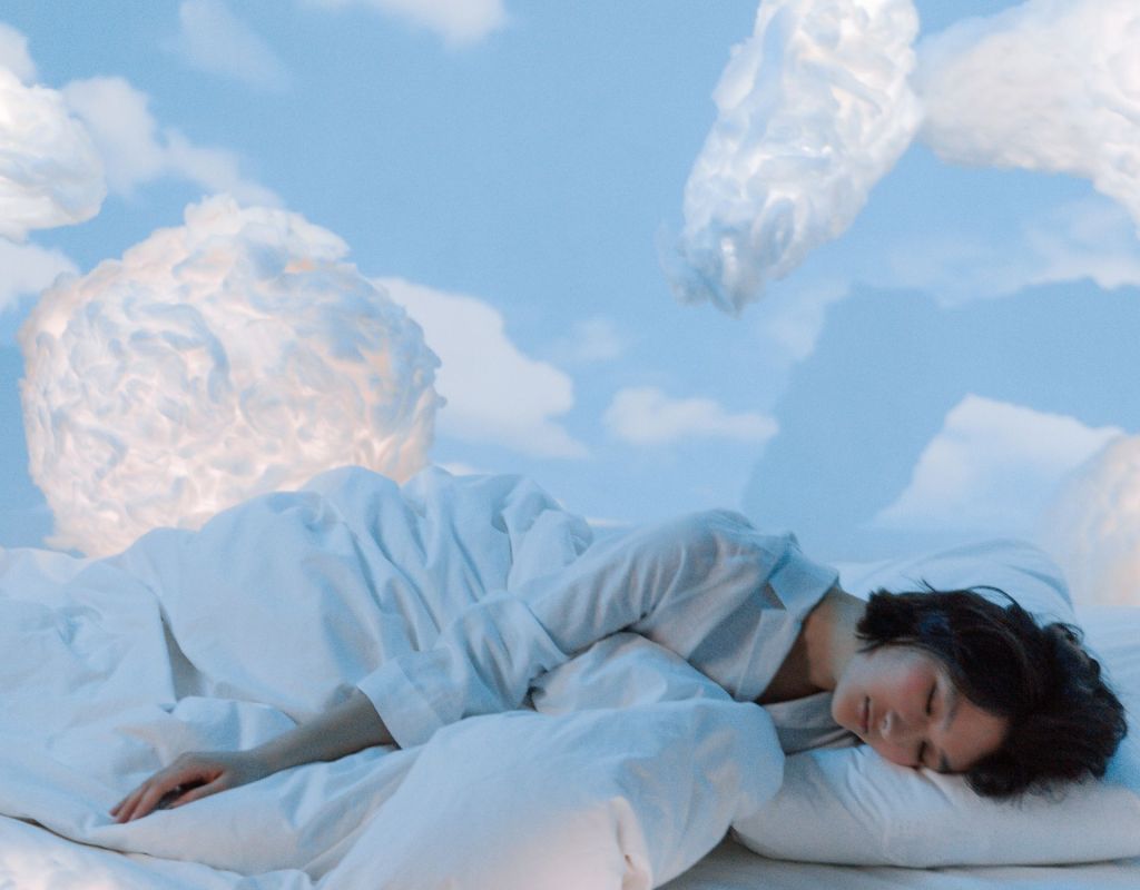 Frau schläft auf Wolken