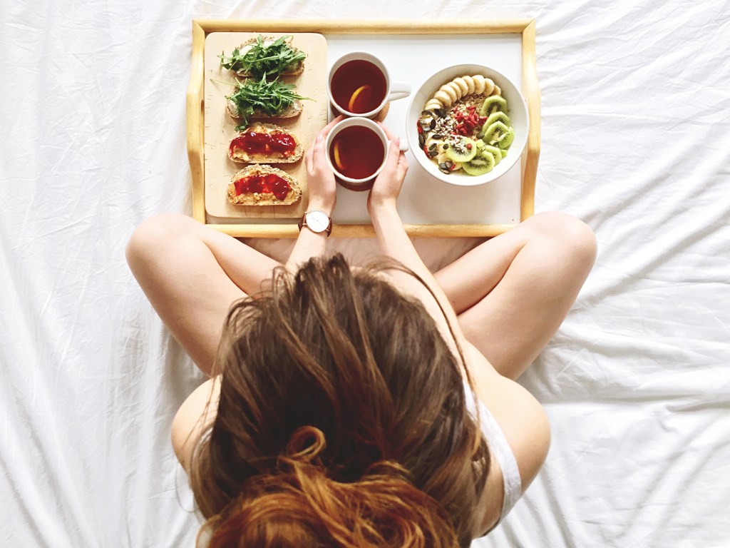 frühstück im bett frau rucola banane bowl müsli tee trinken essen