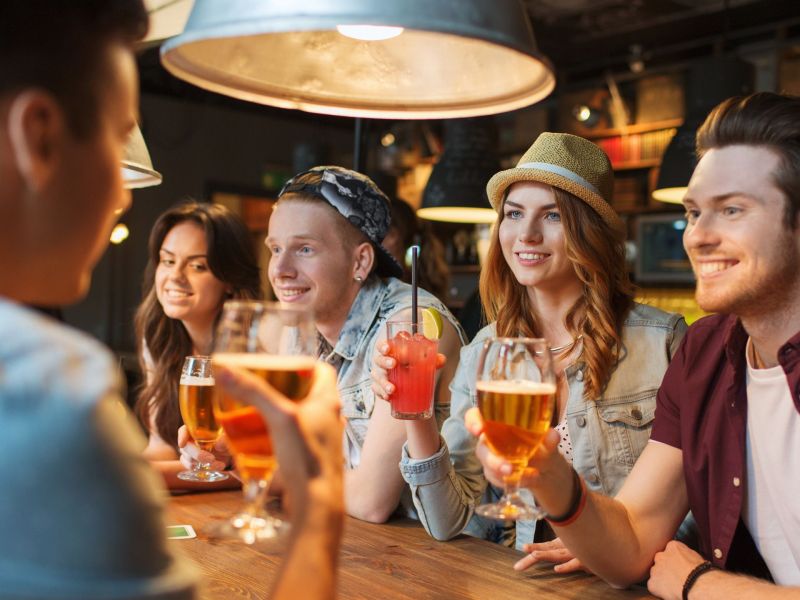 Menschen in einer Bar trinken Bier und Cocktails