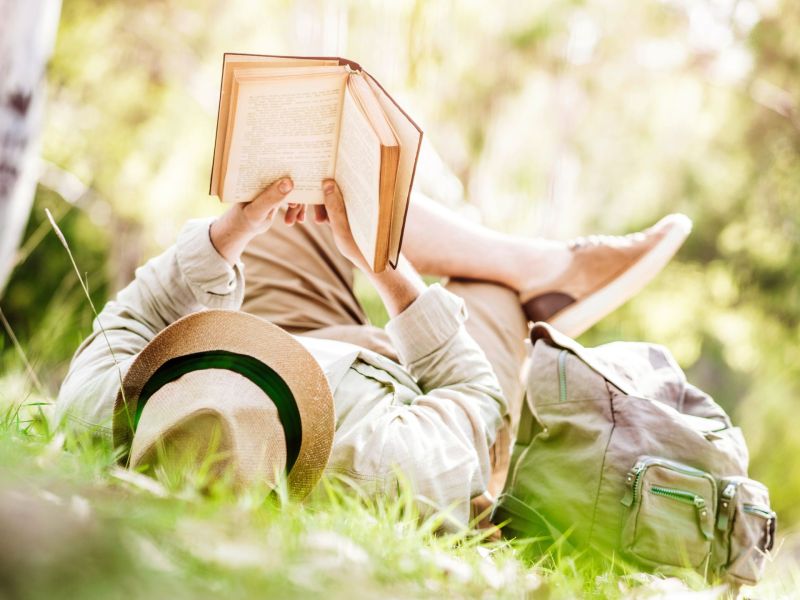 Persönlichkeitstest: Mann liest Buch in der Natur (Symbolbild)