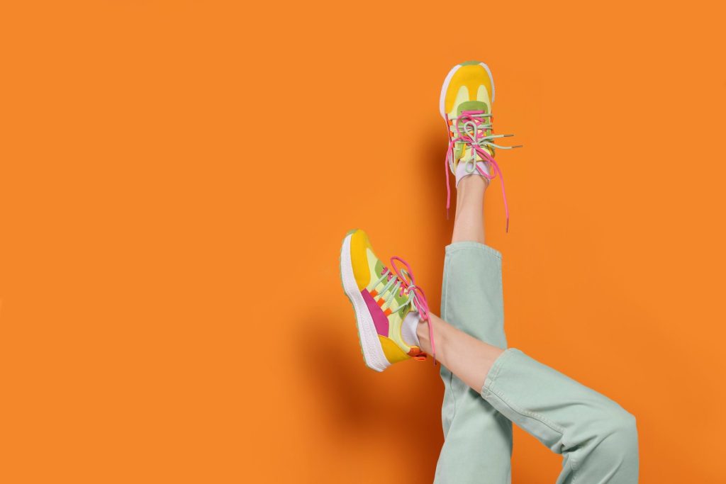 Bunte Sneaker vor orangener Wand