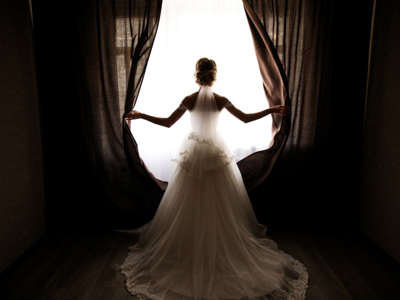 Traumdeutung Brautkleid Frau steht am Fenster
