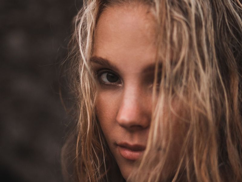 Fettige Haare: Frau mit nassen Haaren – Tipps von der Dermatologin