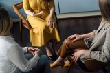 Drei Geschäftsfrauen unterhalten sich im Büro.