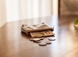 Geldbörse mit Geld auf dem Tisch.